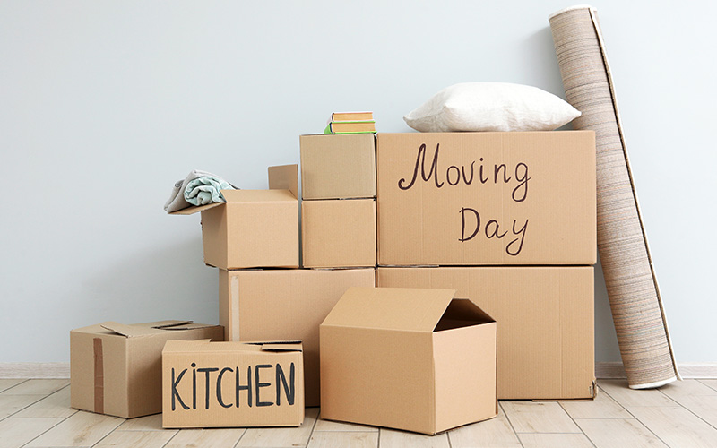 Stacked cardboard boxes labeled for DIY moving day.